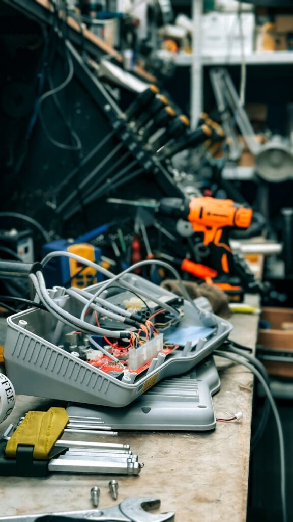 Workshop bench with electronic equipment and tools showcasing a repair environment.